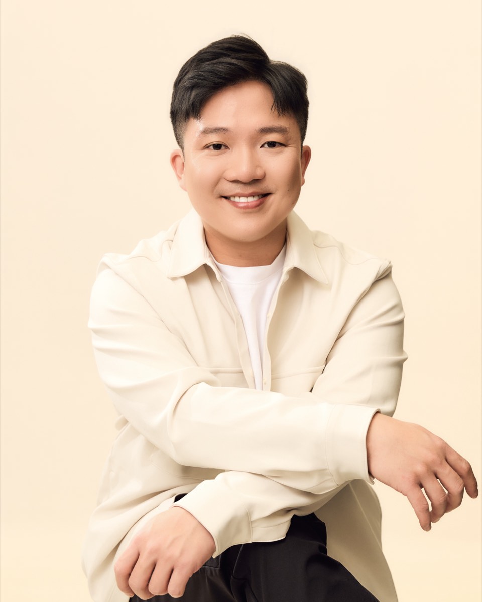 Nicholas Tan, financial adviser, seated and smiling